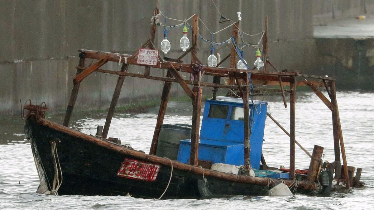 The wooden boat that apparently carried the fishermen is docked at a marina in Yurihonjo,