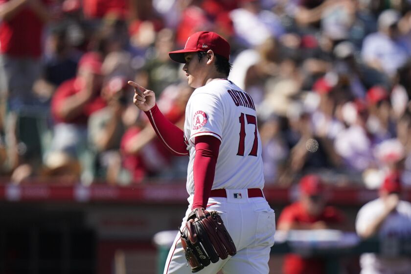 Los Angeles Angels starting pitcher Shohei Ohtani points to catcher Max Stassi.