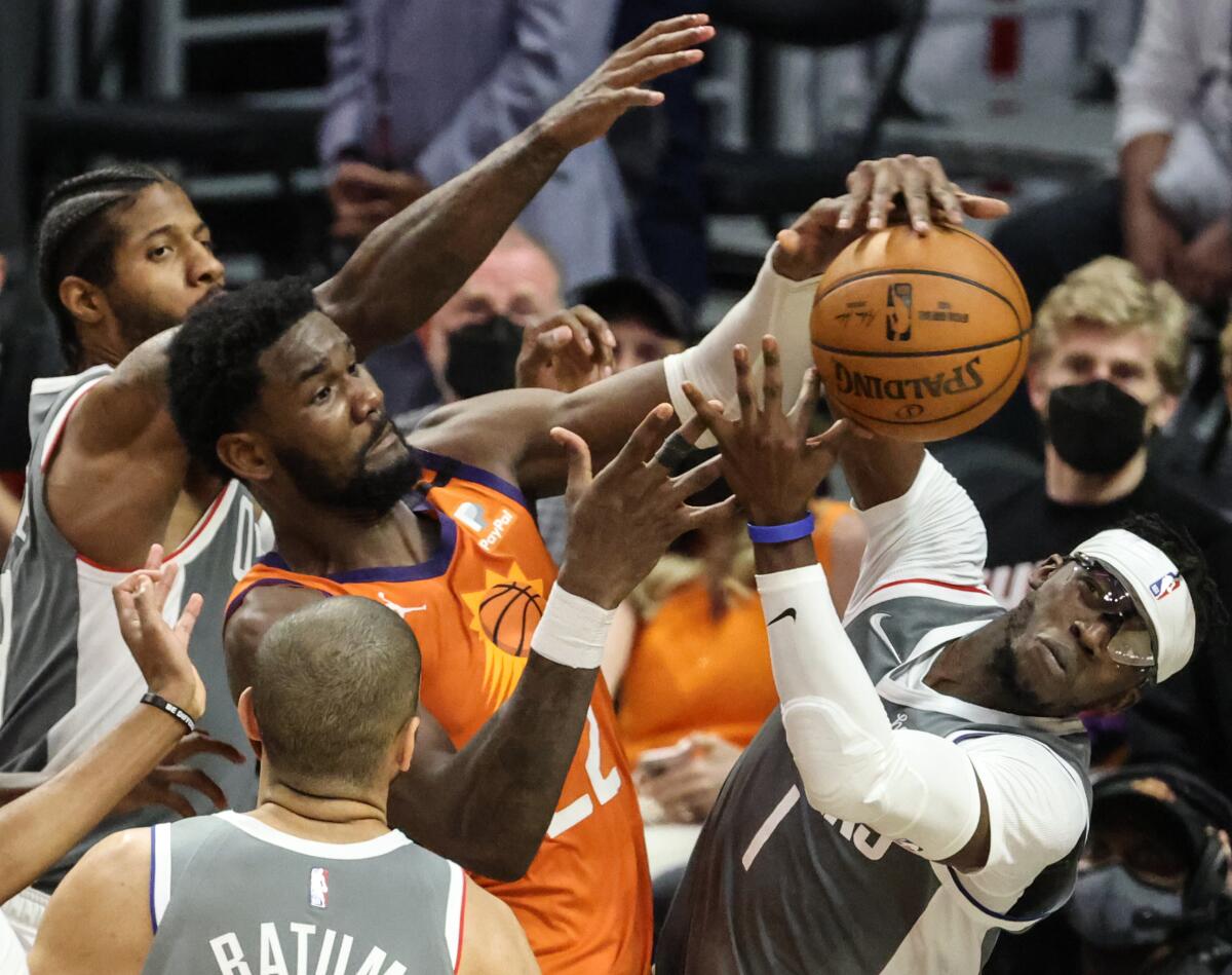 Clippers guard Reggie Jackson battles Suns center Deandre Ayton for a rebound during Game 4.