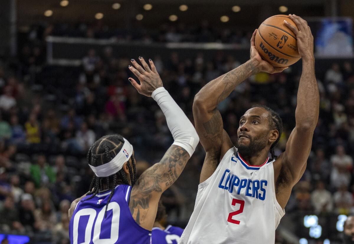 Clippers forward Kawhi Leonard shoots over Utah Jazz guard Jordan Clarkson.