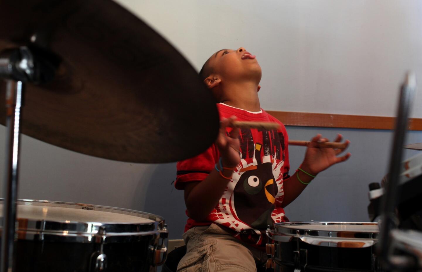 Aspiring drummer Marco Ramirez, 9, gets into his groove at the Neighborhood Music School in Boyle Heights.