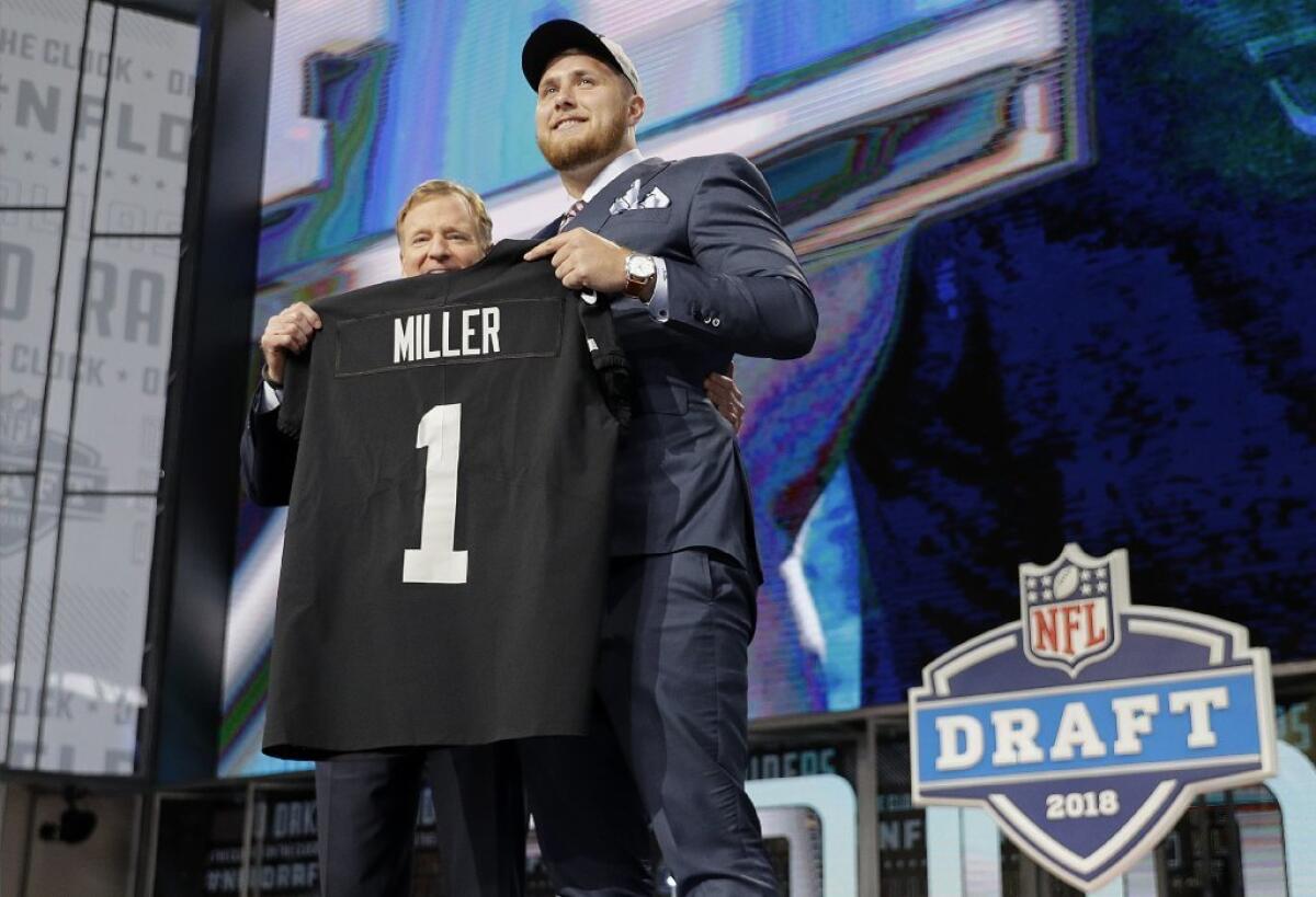 UCLA offensive lineman Kolton Miller is presented a jersey by Roger Goodell after being selected No. 15 by the Oakland Raiders.