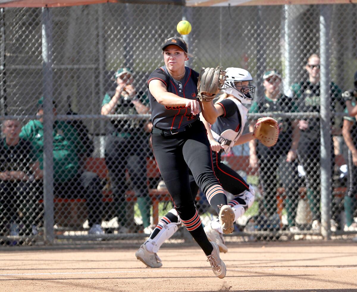 Saige Anderson (47) of Huntington Beach scoops, turns, and throws to first in the quarterfinals on Thursday.