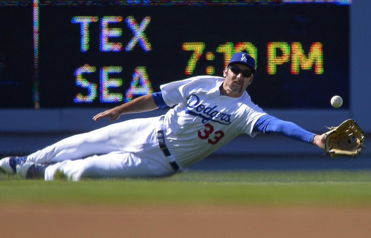 Dodgers left fielder Scott Van Slyke tries to make a catch on a sinking live drive by Cardinals catcher Yadier Molina that went for a run-scoring double in the first inning Saturday.