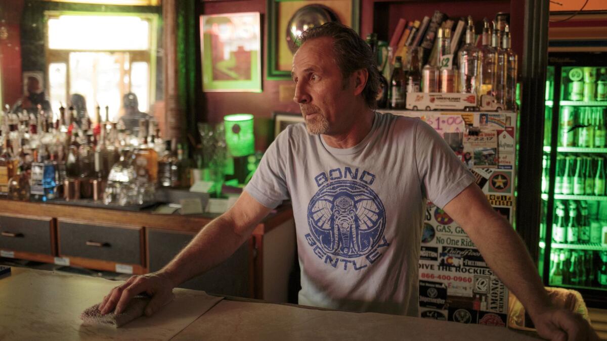 Greg Smith, 59, behind the bar at his Greenlight Tavern in Pueblo.