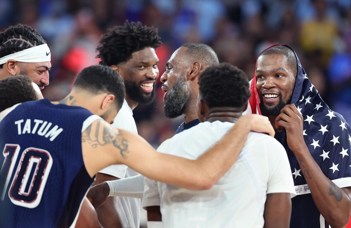 LeBron James, center, celebrates with U.S. teammates 