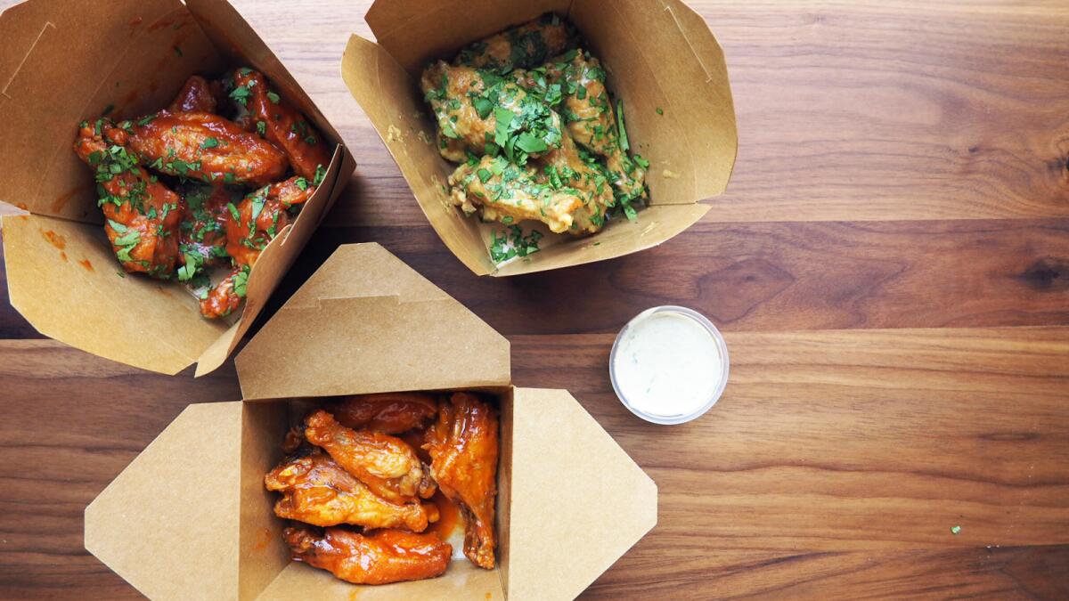 A selection of chicken wings from POV Snack Shop in downtown L.A., including (from left) the pineapple BBQ wings, curry wings and Buffalo wings.