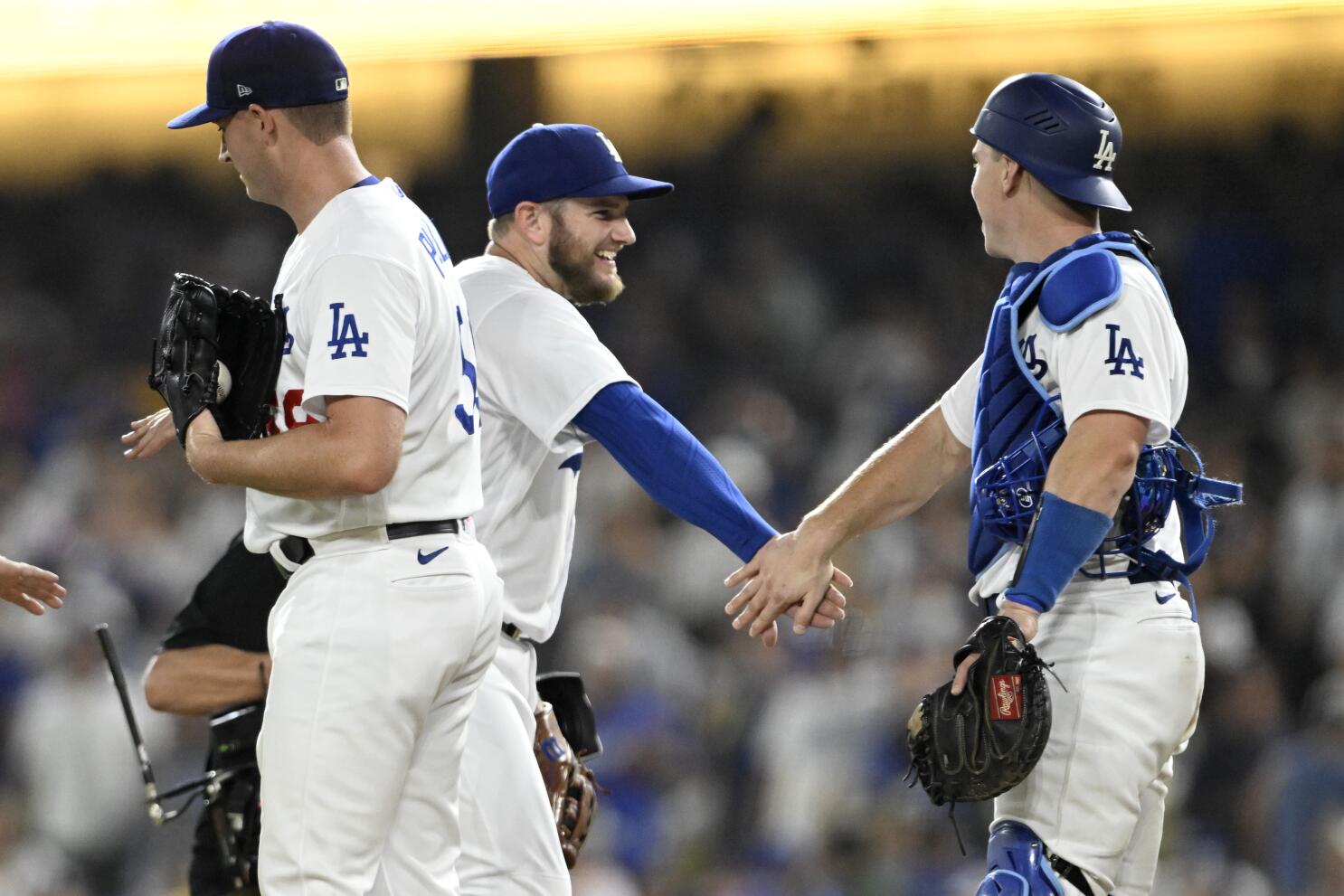 Los Angeles Dodgers' infielder Max Muncy celebrates with teammate