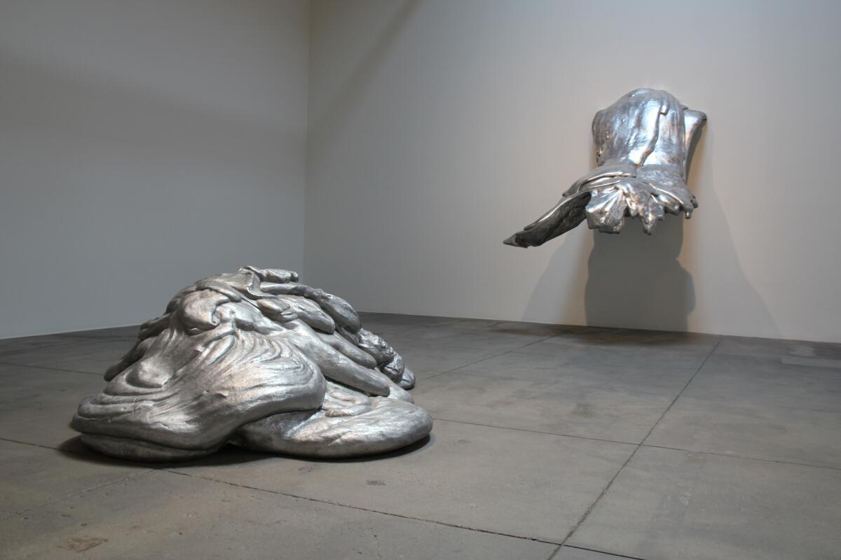 A pair of sculptures by Lynda Benglis: left, "Eat Meat," 1969-75, and "Wing," 1970, which are fabricated out of aluminum.