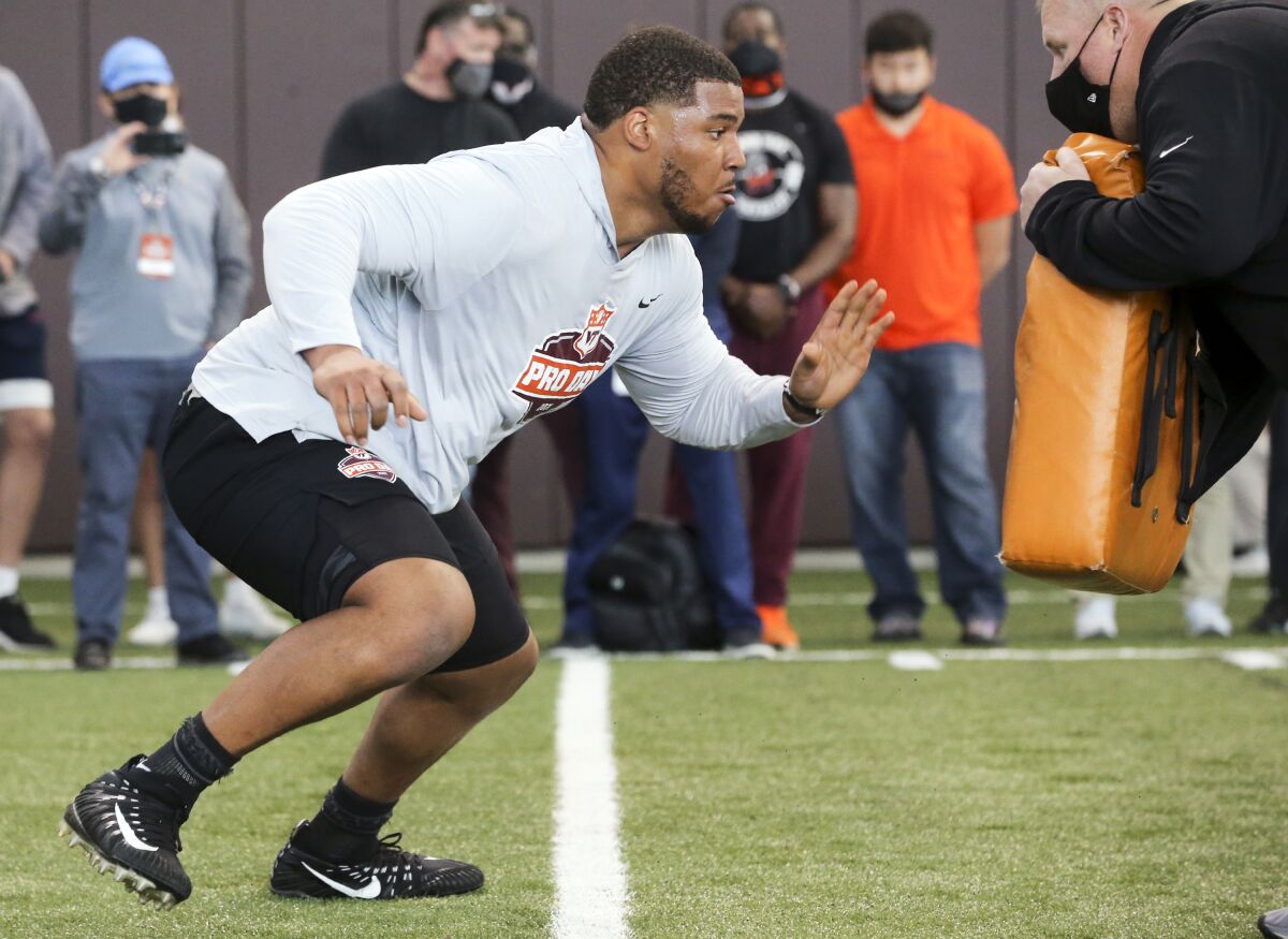 Christian Darrisaw runs a drill at Virginia Tech's pro day.
