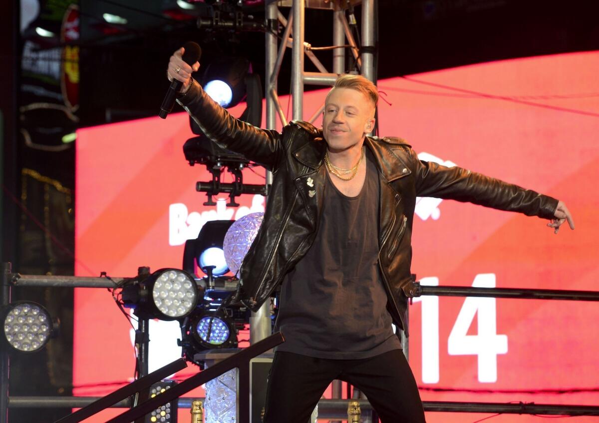 Hip-hop duo Macklemore & Ryan Lewis will perform Jan. 23 in Los Angeles in a concert sponsored by T-Mobile, as the wireless carrier heats up its fight with rival Sprint. Above, Macklemore onstage on New Year's Eve in New York.