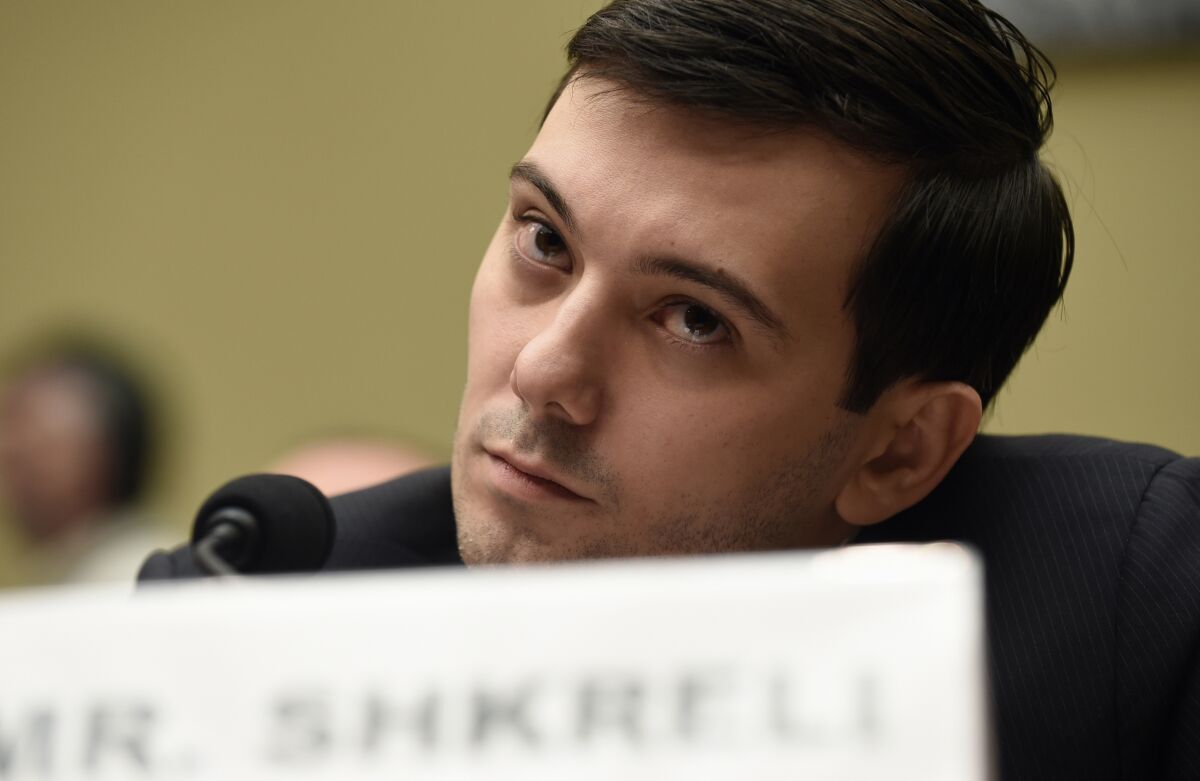 Martin Shkreli sits before a microphone at a congressional hearing