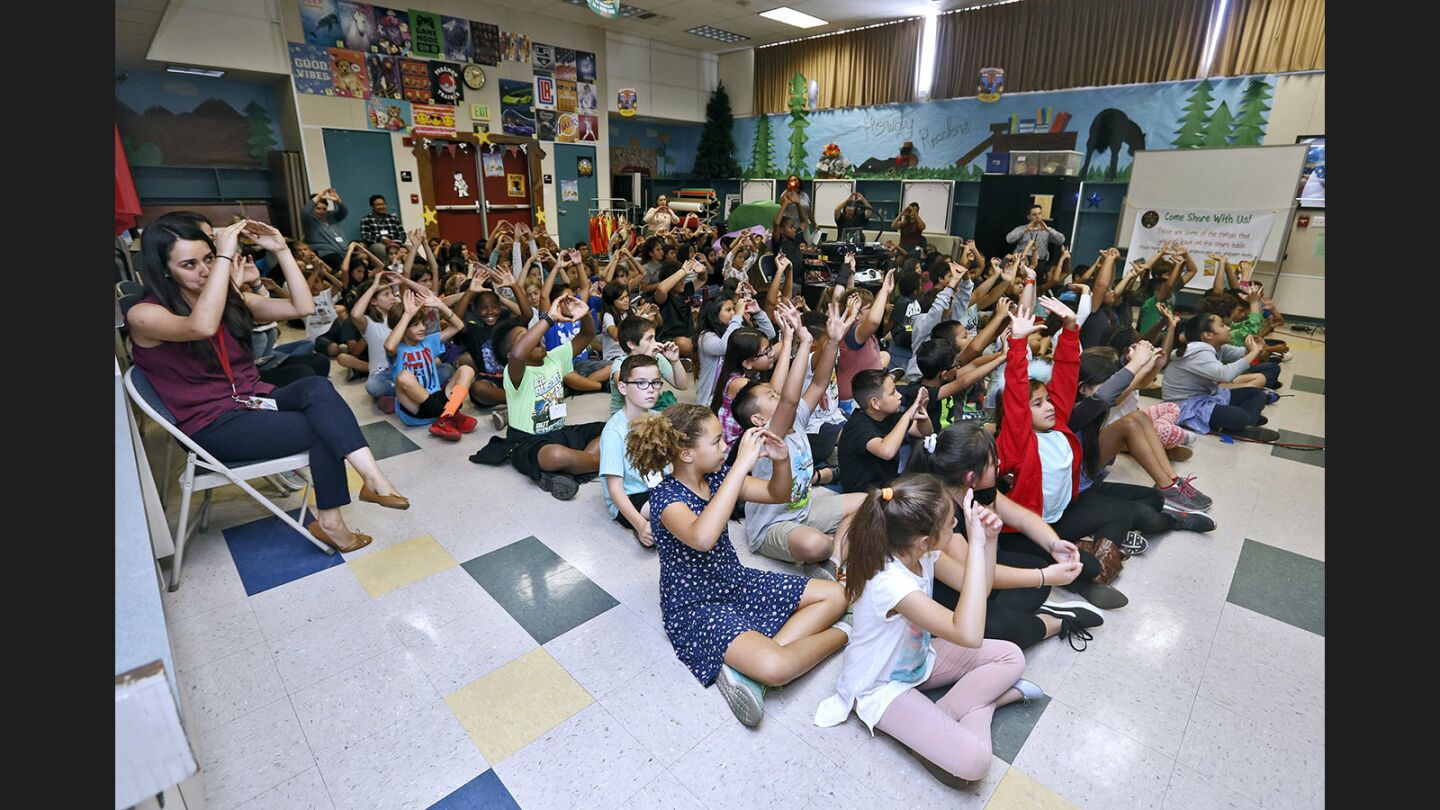 Walt Disney Elementary fourth- and fifth-grade students followed directions during an assembly with the Eco rapper, who talked and rapped about saving the environment, at the Burbank school on Tuesday.