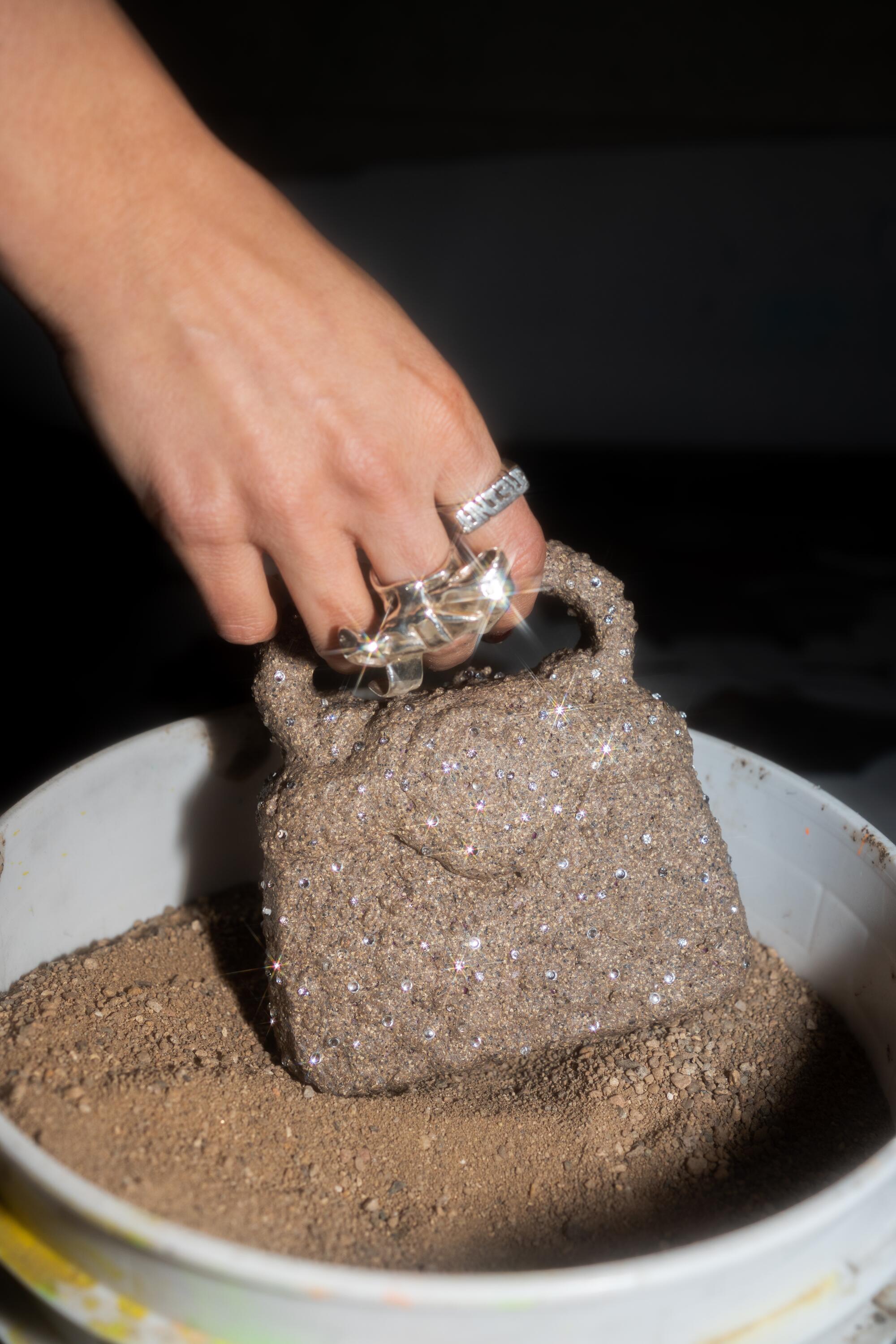 A plastic purse encrusted with gravel and cubic zirconia.