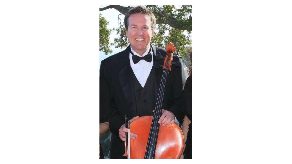 Newland Elementary School principal and professional cellist Chris Christensen poses for a photo at a gig.