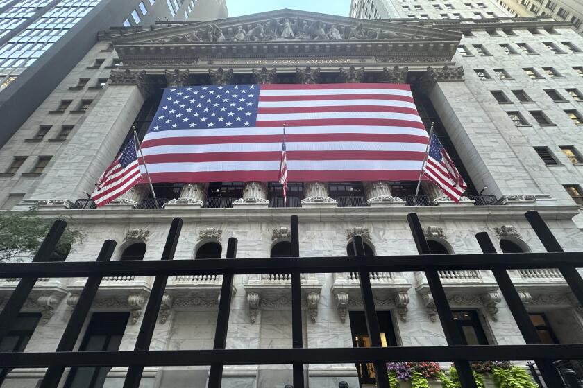 American flag hang from the front of the New York Stock Exchange on Tuesday, Sept. 10, 2024, in New York. (AP Photo/Peter Morgan)