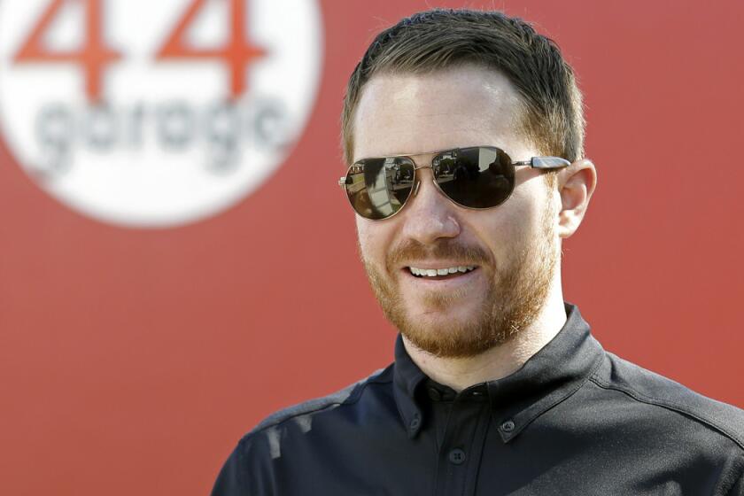 NASCAR driver Brian Vickers walks though the garage area at Daytona International Speedway on Friday.