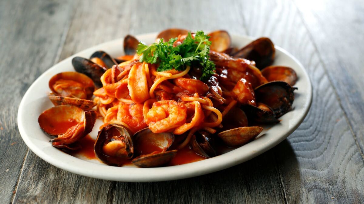 Spaghetti di mare, a popular entree at Giardino Neighborhood Cucina, is a dish Marco Provino often cooked for his wife, Karina Kravalis, when they were dating.