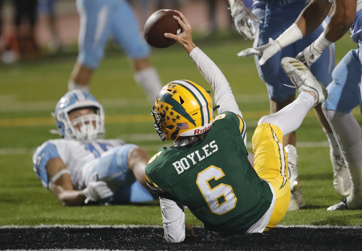 Edison quarterback Braeden Boyles lands in the end zone for a rushing touchdown.