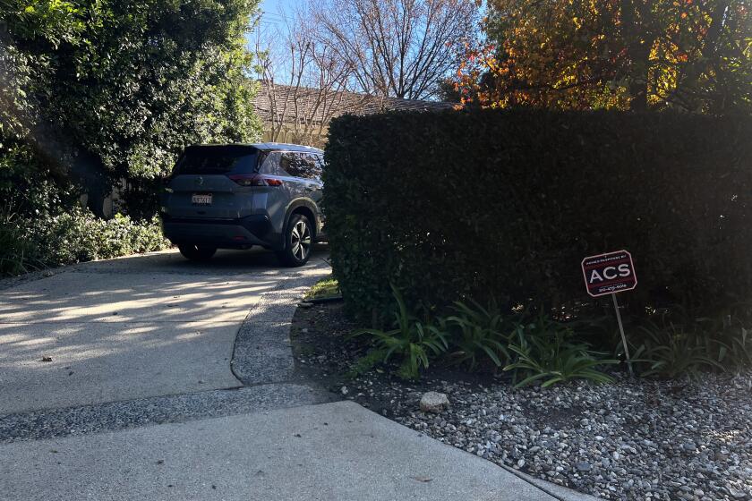 Encino, California-Photos show a sign for the private security company ACS Security outside a house in Encino. An ACS Security guard entered that home and shot the 88-year-old woman who lived there on New Year's Eve. (Noah Goldberg/Los Angeles Times)