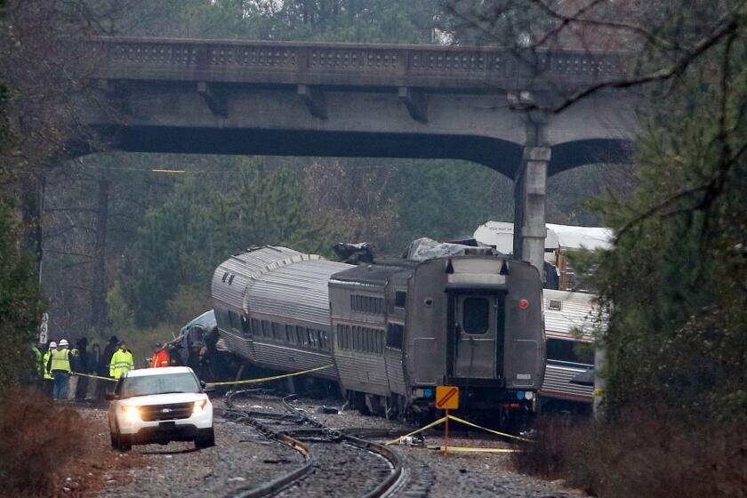 CAYCE, SC - FEBRUARY 04: Investigators make their way around the train wreckage under the Charleston Highway overpass where two trains collided early Sunday morning on February 4, 2018 in Cayce, South Carolina. According to reports, two people were killed and over 100 injured when the Amtrak train collided with a freight train. (Photo by Bob Leverone/Getty Images) *** BESTPIX *** ** OUTS - ELSENT, FPG, CM - OUTS * NM, PH, VA if sourced by CT, LA or MoD **