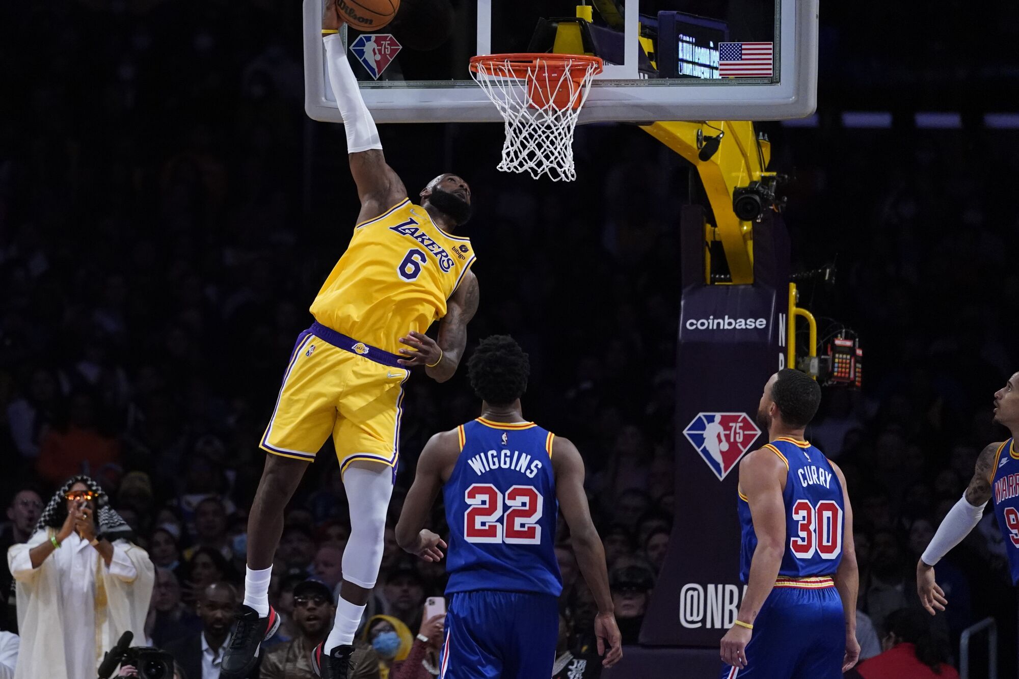 Lakers forward LeBron James elevates for a reverse dunk against the Warriors.