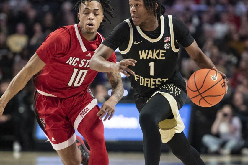 Wake Forest guard Tyree Appleby (1) moves around the defense of North Carolina State guard Breon Pass (10) in the first half of an NCAA college basketball game on Saturday, Jan. 28, 2023, in Winston-Salem, N.C. (Allison Lee Isley/The Winston-Salem Journal via AP)
