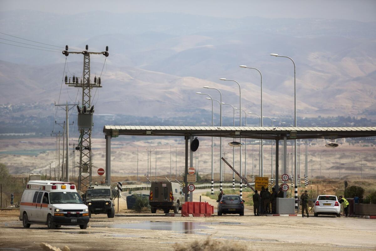 Israeli soldiers stand Monday at the entrance to the Allenby border crossing between Jordan and the West Bank. Israeli soldiers shot and killed a Jordanian judge at the crossing during the day.