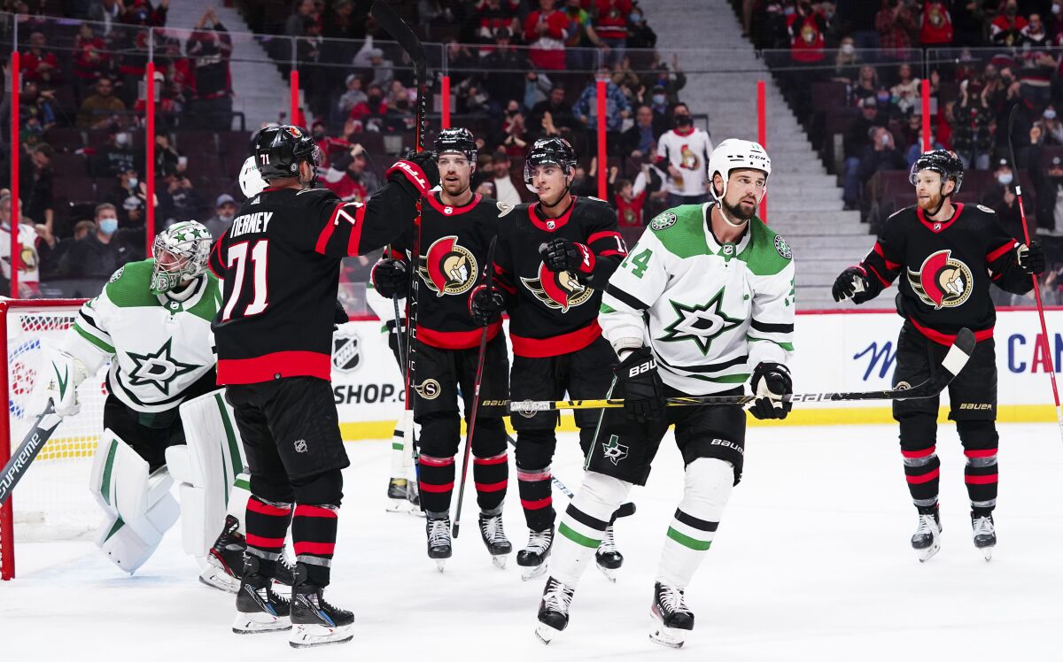Ottawa Senators' Chris Tierney (71) celebrates his second goal against the Dallas Stars with teammates during the second period of an NHL hockey game, Sunday, Oct. 17, 2021, in Ottawa, Ontario. (Sean Kilpatrick/The Canadian Press via AP)