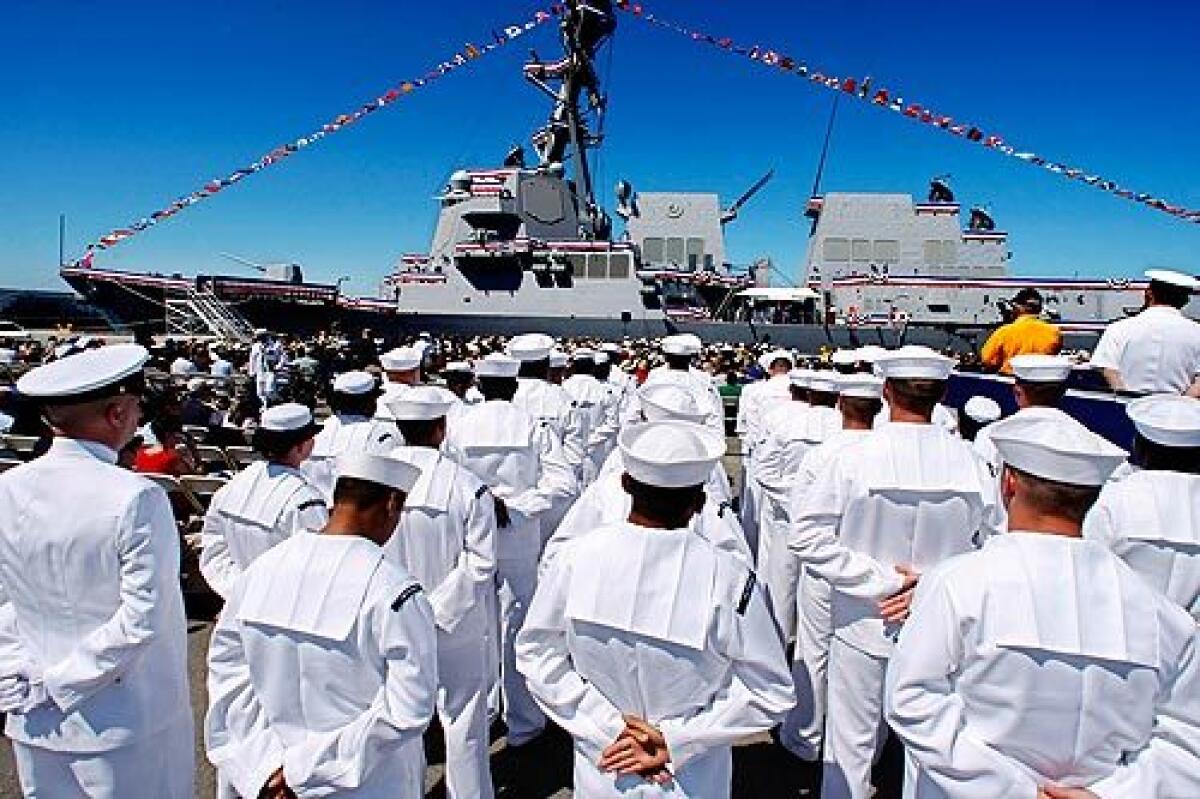 Crew members stand at attention during the commissioning ceremony of the Navy's new missile destroyer Stockdale at Naval Base Ventura County in Port Hueneme. The ship is named for the late Vice Adm. James Stockdale, who was a POW in Vietnam and Ross Perot's running mate in the 1992 presidential election.