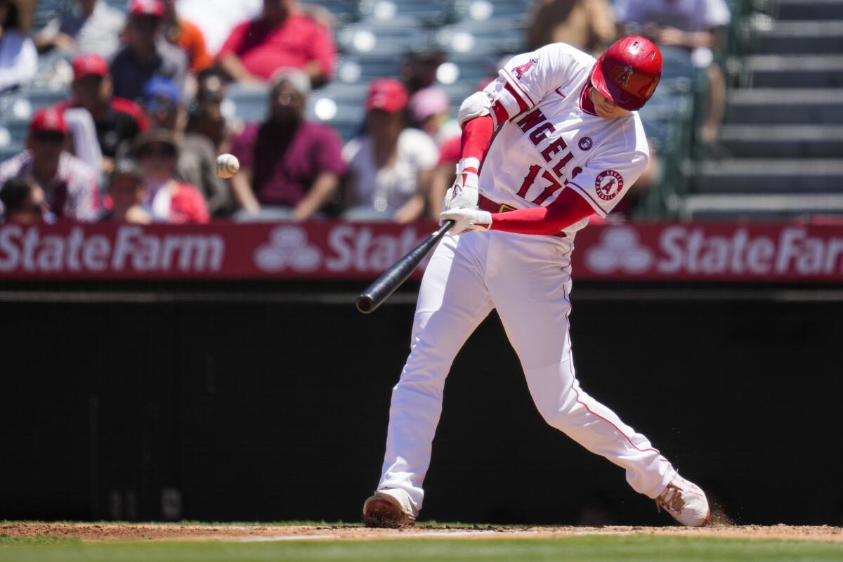 Angels designated hitter Shohei Ohtani hits a home run against the Baltimore Orioles on Sunday.