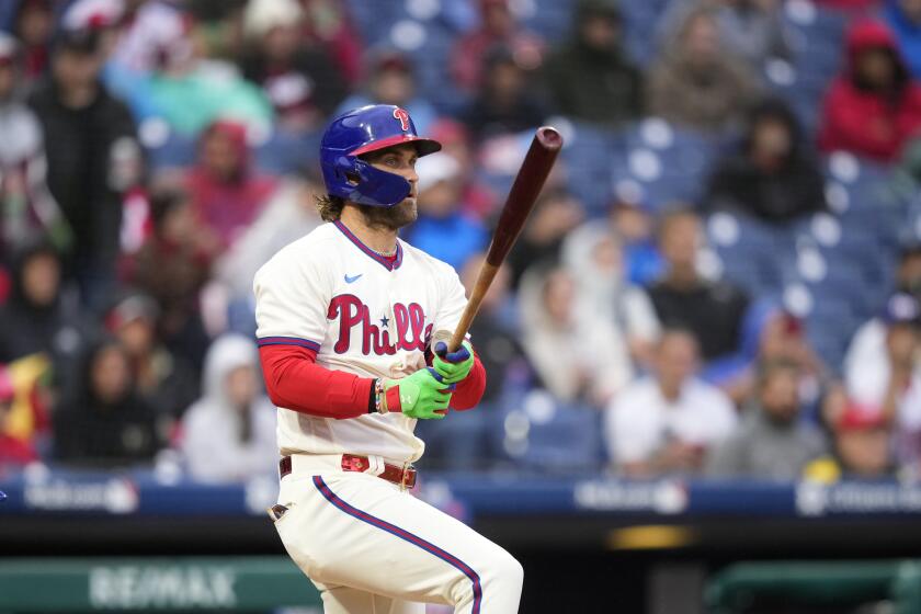 Philadelphia Phillies' Bryce Harper follows through after hitting a two-run single against New York Mets pitcher Jose Quintana during the fifth inning of a baseball game, Saturday, Sept. 23, 2023, in Philadelphia. (AP Photo/Matt Slocum)