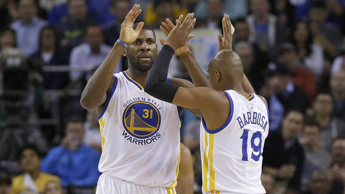 Golden State Warriors center Festus Ezeli, left, and guard Leandro Barbosa celebrate during a win over the Washington Wizards on Monday.