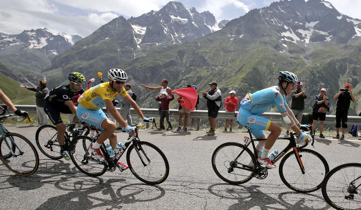 Vincenzo Nibali, wearing the overall leader's yellow jersey, follows teammates as they climb Lautaret pass in the Alps during the 14th stage of the Tour de France on Saturday.