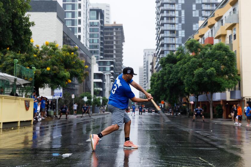 Edwin Rodriguez of Sugar Hill, a team based in New York City, swings during the 25th annual Labor Day Stickball Tournament at Little Italy on Saturday, Sept. 2, 2023. His team beat the Chargers, who are from Tampa Bay, Florida, 6-0.