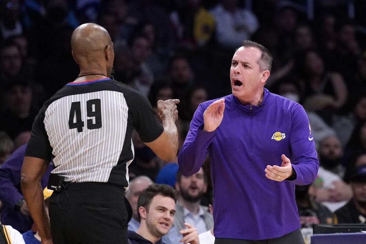 Lakers coach Frank Vogel, right, receives a technical foul from referee Tom Washington.