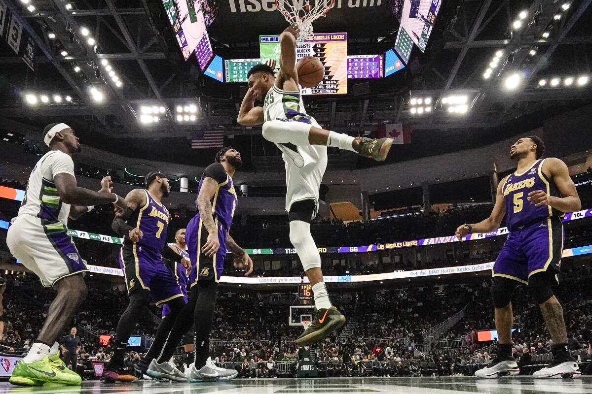The Milwaukee Bucks' Giannis Antetokounmpo dunks in front the Lakers Wednesday in Milwaukee.