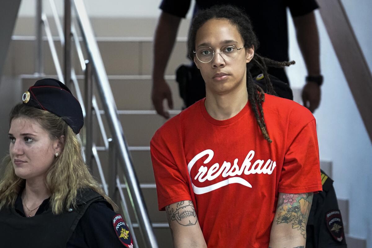 FILE - WNBA star and two-time Olympic gold medalist Brittney Griner is escorted to a courtroom for a hearing, in Khimki just outside Moscow, Russia, Thursday, July 7, 2022. The drug possession trial of WNBA star Griner has resumed, with the head of the Russian club she plays for in the offseason and a teammate from that squad testifying in support of her character and what she has meant for women’s basketball in the country. Griner, who pleaded guilty last week, did not testify as expected at the third day of the trial. (AP Photo/Alexander Zemlianichenko, File)