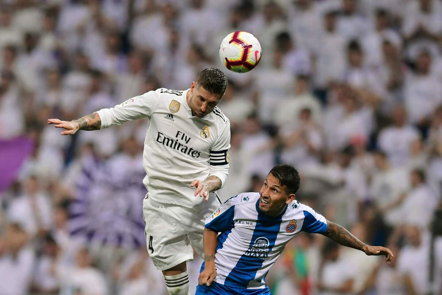 Real Madrid's Spanish defender Sergio Ramos (L) jumps for the ball next to Espanyol's Paraguayan forward Hernán Perez during the Spanish league football match between Real Madrid CF and RCD Espanyol at the Santiago Bernabeu stadium in Madrid on September 22, 2018. (Photo by JAVIER SORIANO / AFP)JAVIER SORIANO/AFP/Getty Images ** OUTS - ELSENT, FPG, CM - OUTS * NM, PH, VA if sourced by CT, LA or MoD **