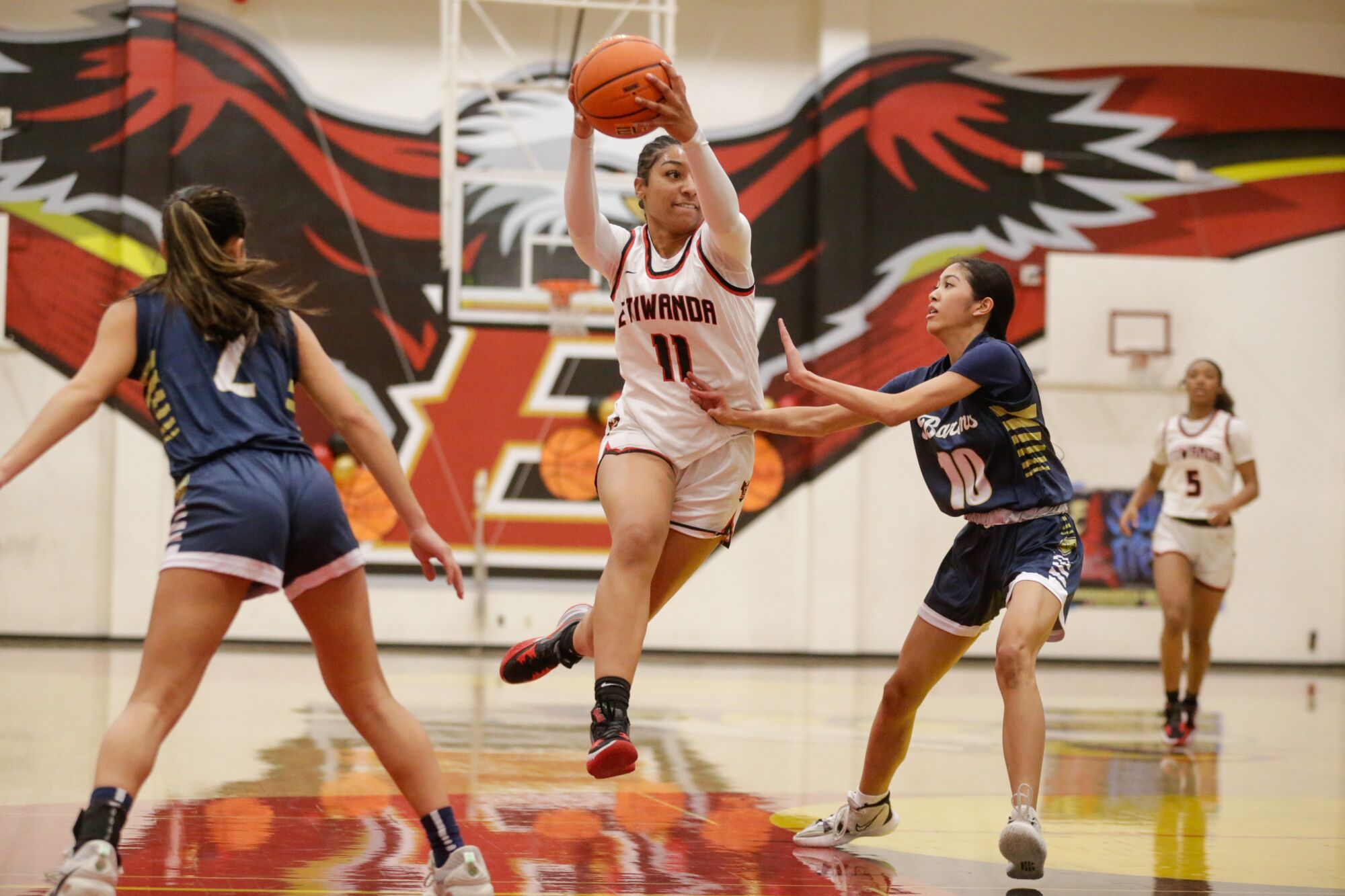 Etiwanda center Kennedy Smith split two defenders on a drive down the lane.