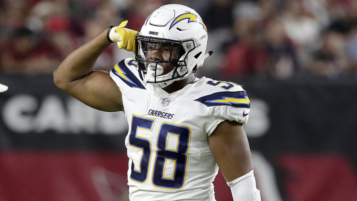 Chargers linebacker Uchenna Nwosu flexes after making a play against the Cardinals during a preseason game.