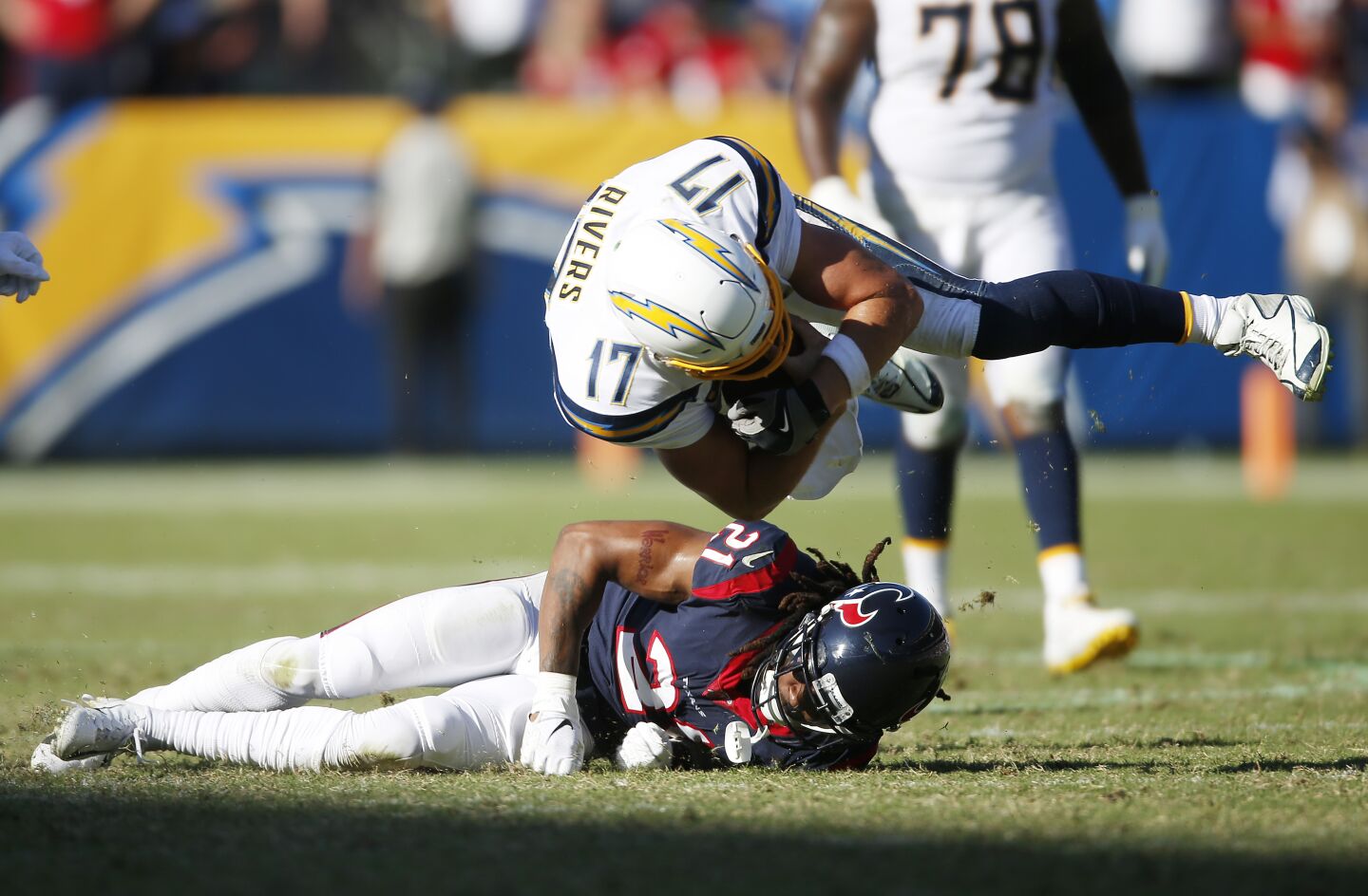 Los Angeles Chargers Philip Rivers is tripped up by Houston Texans Bradley Roby in the 4th quarter in Carson on Sept. 22, 2019.