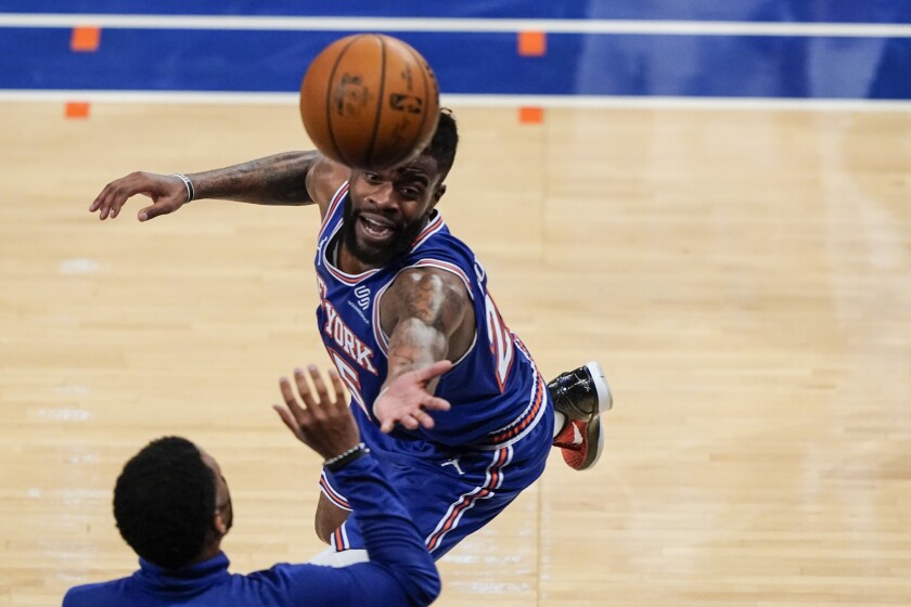 New York Knicks' Reggie Bullock chases a ball out of bounds during the second half of an NBA basketball game against the San Antonio Spurs Thursday, May 13, 2021, in New York. (AP Photo/Frank Franklin II, Pool)