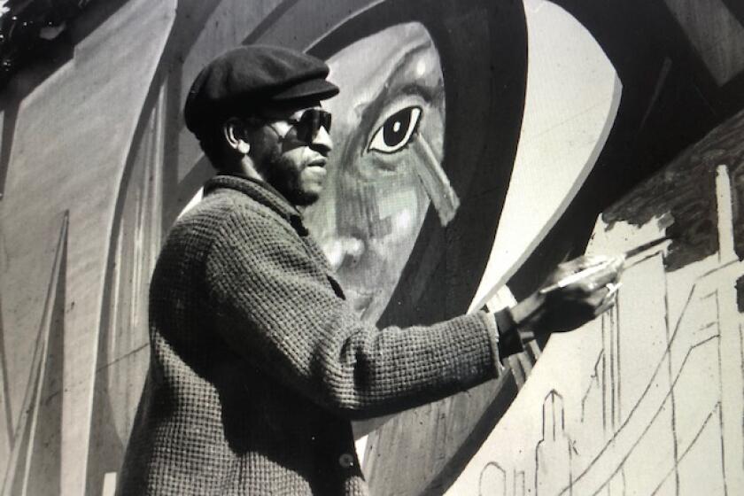 Roderick Sykes at work on one of his murals in an undated photo. Sykes, the co-founder of St. Elmo Village, died at 75.