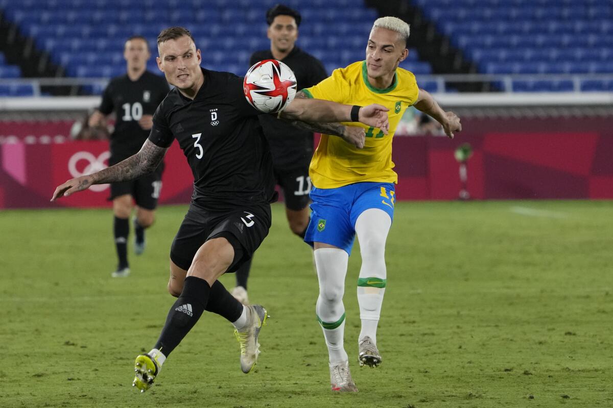 Germany's David Raum, left, and Brazil's