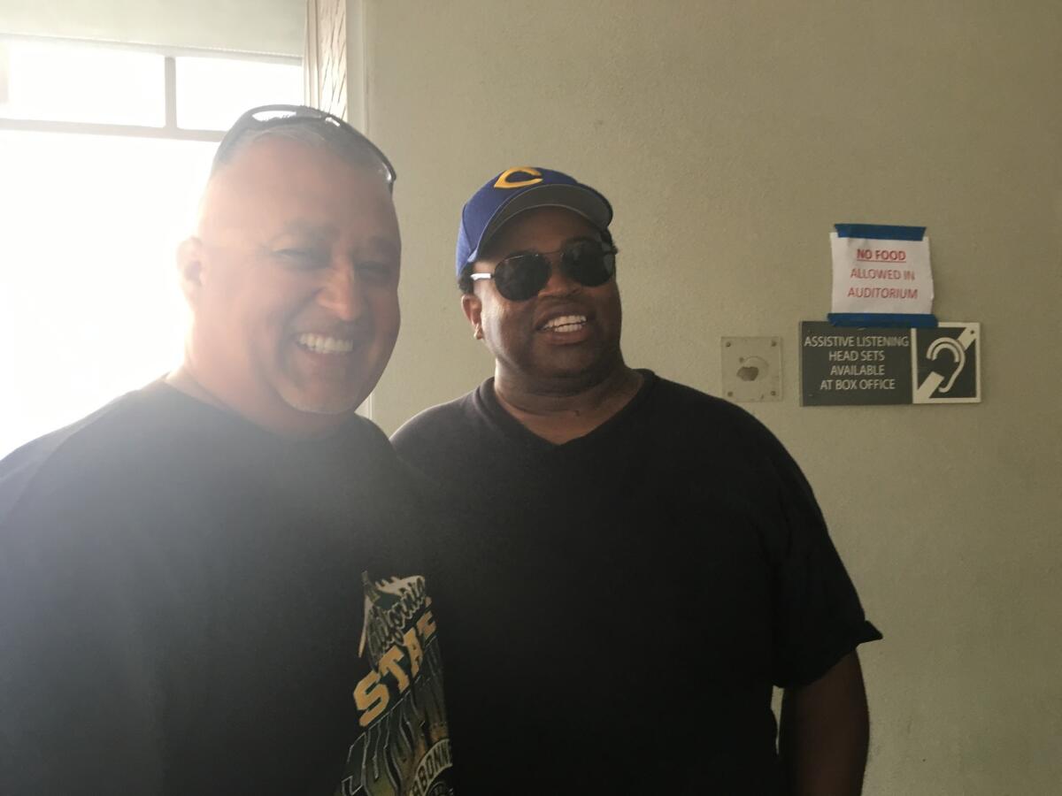 Narbonne Coach Manuel Douglas (left) and Crenshaw Coach Robert Garrett are all smiles before City Section football coaches meeting on Saturday.