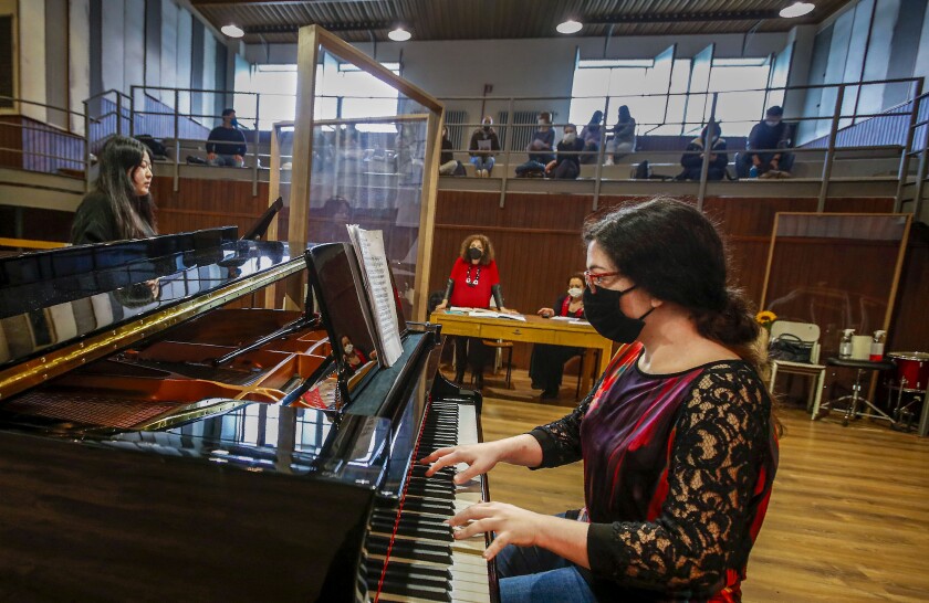 Ylenia Labanca, right, plays piano with a singer Yidan Fu, behind a transparent panel to curb the spread of COVID-19, during a lesson at the Giuseppe Verdi Music Conservatory, in Milan, Italy, Thursday, April 29, 2021. Whatever the instrument, flute, violin or drums, students at Italy's oldest and largest music conservatory have been playing behind plexiglass screens during much of the pandemic as the Conservatory found ways to preserve instruction throughout Italy’s many rolling lockdowns. (AP Photo/Antonio Calanni)