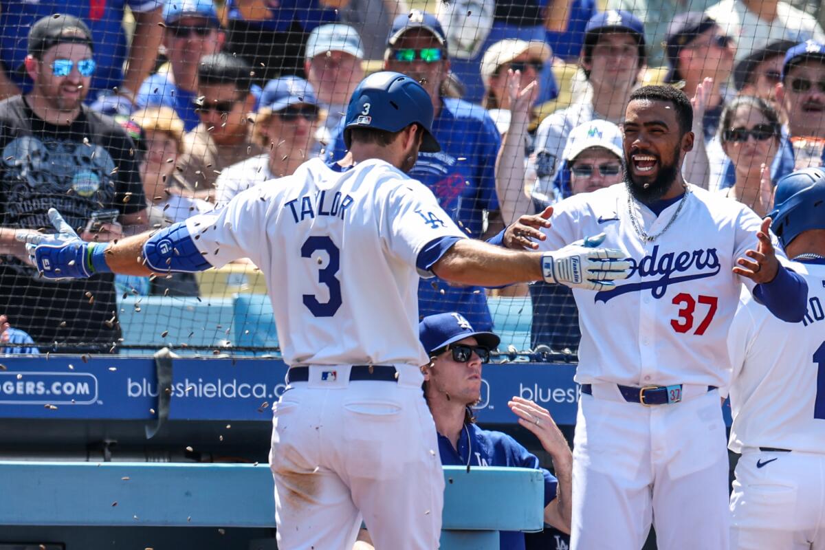 Dodgers outfielder Teoscar Hernández showers teammate Chris Taylor with sunflower seeds after Taylor hit a home run.