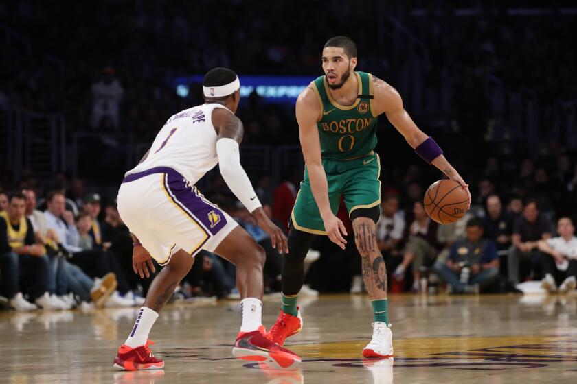 Celtics forward Jayson Tatum sets up the offense while guarded by Lakers guard Kentavious Caldwell-Pope on Feb. 22, 2020, at Staples Center.