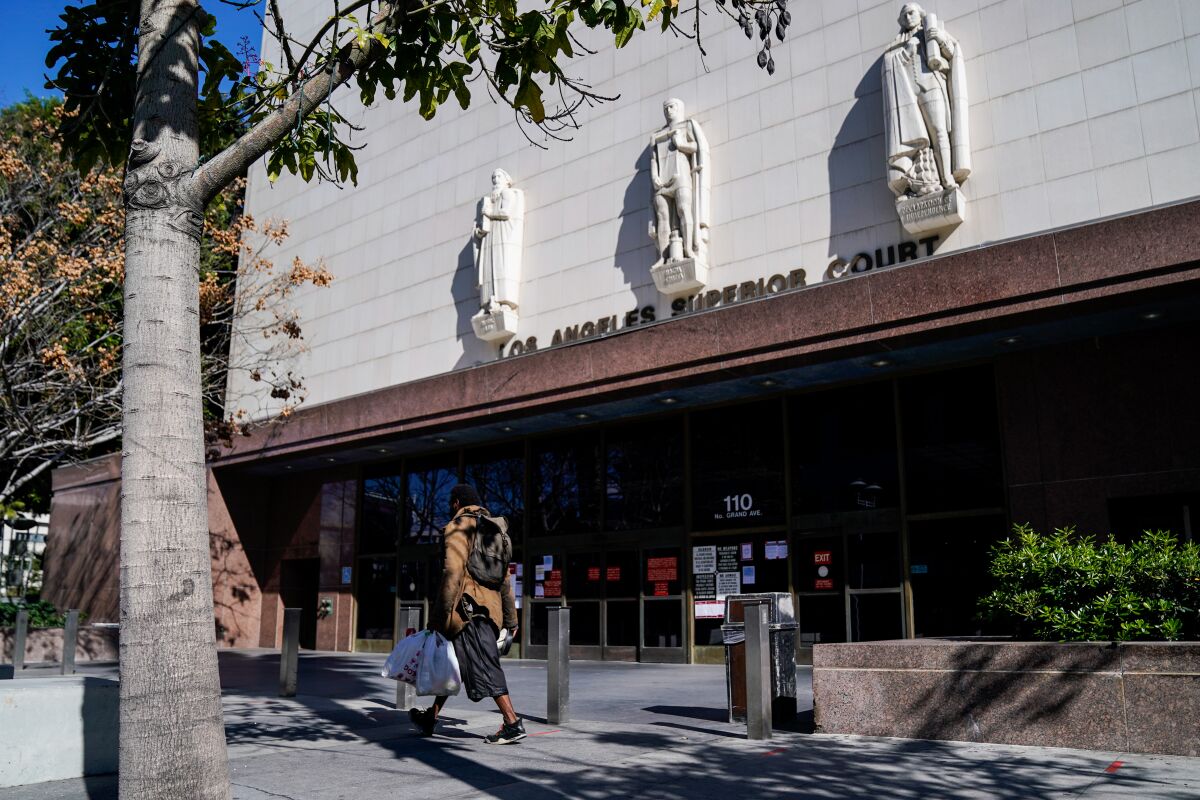 A man walks by the Stanley Mosk Courthouse in downtown Los Angeles 